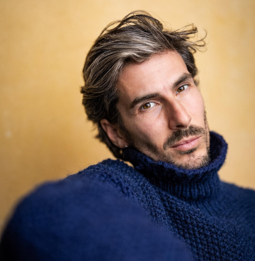 Portrait of Spanish actor Álvaro Cea wearing a blue knit jumper